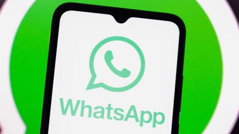 WhatsApp logo displayed on a smartphone against a green and white background