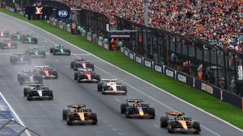 Lando Norris' McLaren leads the field at the start of the Australian Grand Prix