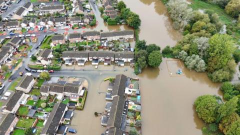 Drone footage shows flooding in Abingdon from the River Ock - with water spilling into residential streets around the river. 