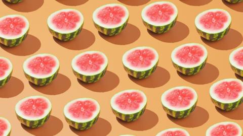 Rows of halved watermelons on a pale orange background