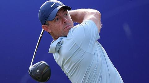 Rory McIlroy holds a golf club over his shoulder