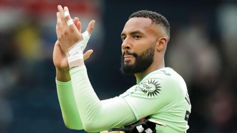 Swansea City goalkeeper Lawrence Vigouroux applauds