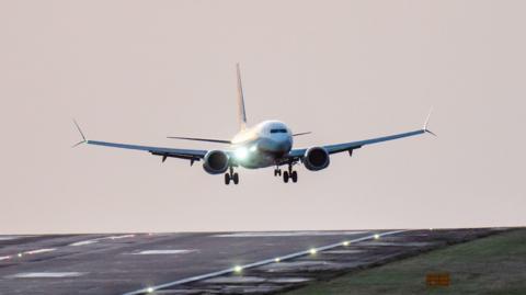 A plane lands on the runway at Leeds Bradford Airport