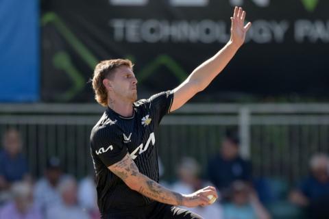 Surrey seamer Conor McKerr bowls a ball