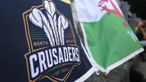 North Wales Crusaders flag alongside Welsh dragon flag
