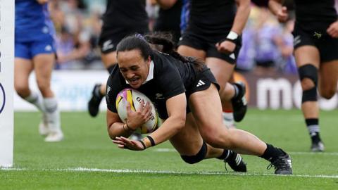 Ruahei Demant dives over the line holding the ball to score a try for New Zealand