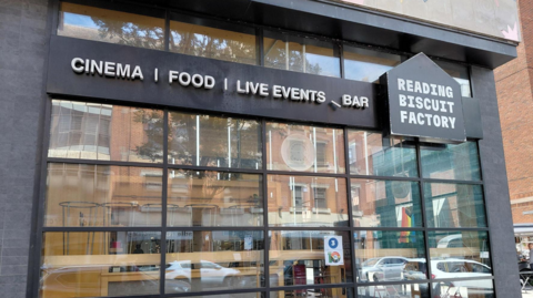 A Google Maps picture of the entrance to Reading Biscuit Factory, with a sign that says "Cinema | food | bar".