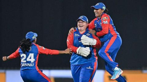 Delhi Capitals' Lizelle Lee celebrates with teammates after taking the wicket of Gujarat Giants' Sophie Devine