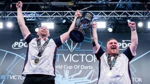 Luke Humphries and Luke Littler lift the World Cup of Darts trophy