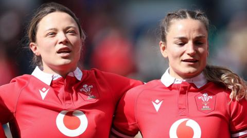 Alisha Joyce-Butchers and Jasmine Joyce-Butchers sing the national anthem side by side before a Wales game