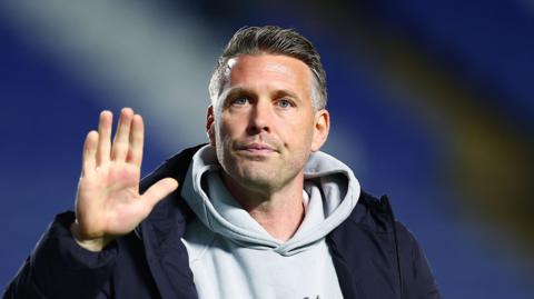 A close-up of former Middlesbrough boss Rob Edwards waving