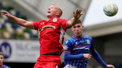 Action from Cliftonville against Linfield at Windsor Park 