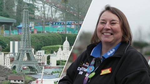 Paula Laughton wearing her Lego uniform and smiling at the camera.
