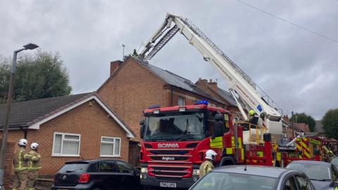 An aerial ladder platform set up in a residential street