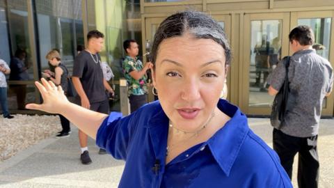 ý correspondent Shaimaa Khalil stands outside court building in Saipan