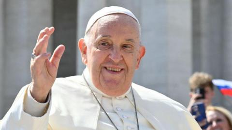 Pope Francis greets visitors at the Vatican 