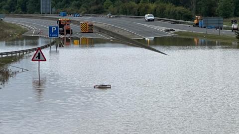 A road submerged by water after heavy rainfall. 