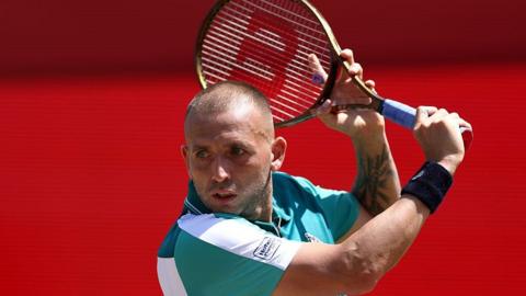 Dan Evans hits a shot