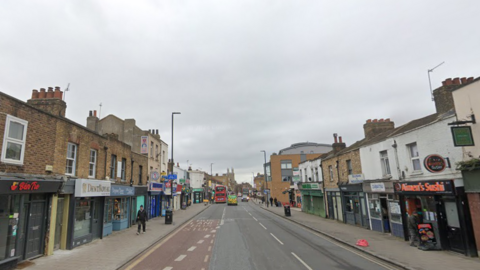 A Google street view of a street with shops lining the side
