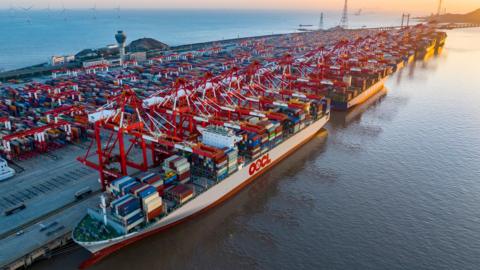 The sun rises over the East China Sea at Yangshan Deep Water Port in Shanghai, China.