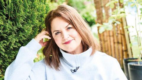 A close up image of Ruth Jones outdoors smiling to camera