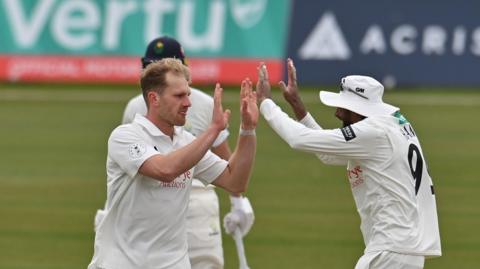 Dillon Pennington of Notts gets a high-five from his Notts captain Haseeb Hameed