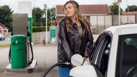 Oman putting petrol in car