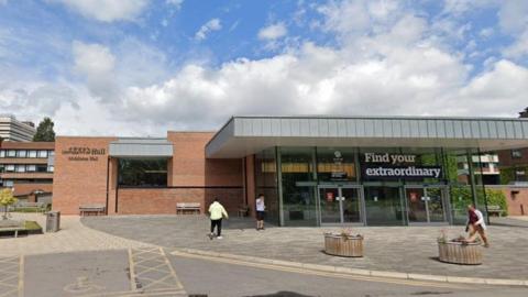 Middleton Hall and other buildings at the University of Hull. A large window display reads 'Find your extraordinary'