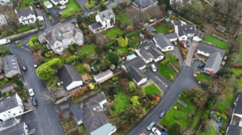 An aerial view of the village of Silverdale with its houses and green gardens.