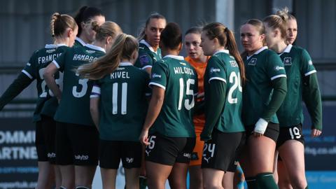 Plymouth Argyle Women in a pre-game huddle