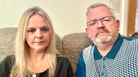 Tanya Linehan and father Phil sitting at home on a sofa 