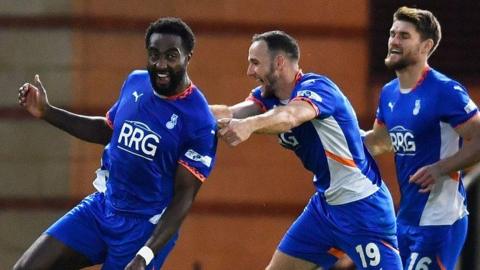 Oldham players celebrate with goalscorer Manny Monthe