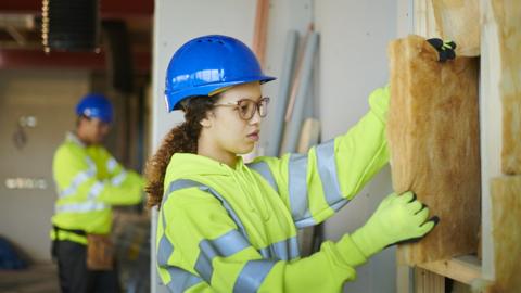 A construction student learning on site.