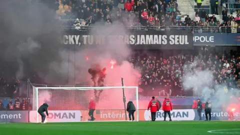 Supporters let off flares in a Ligue 1 game between Montpellier and Saint-Etienne