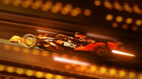 A modern F1 car with stylised overlay graphics and bright lights. 