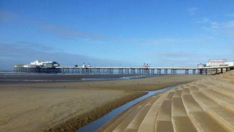 Steps leading to the sandy beach near Blackpool's North Pier.
