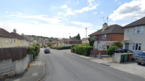 Colebrook Road showing houses on either side of the street, there are some cars parked along it further down.