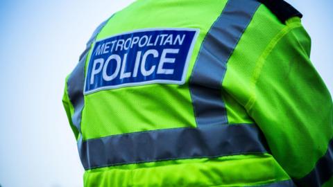 A Metropolitan Police officer seen from behind. 