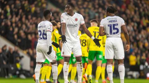 Luton players react animatedly during the Championship match at Norwich.