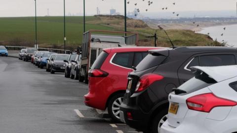 A row of cars parked along Saltburn's Marine Parade, which faces out to sea.