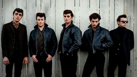 Ellis Murphy as Paul McCartney, Patrick Gilmore as Pete Best, Rhys Mannion as John Lennon, Harvey Brett as George Harrison, Louis Landau as Stu Sutcliffe. All five are dressed in black trousers and black jackets - three of them leather.