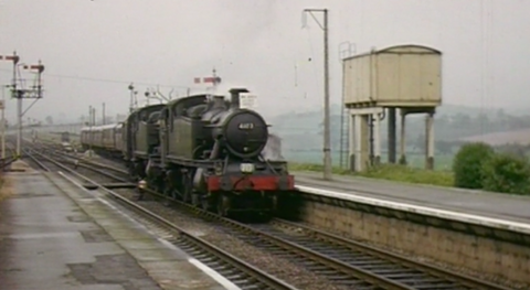 An archive image of an old train pulling into a station during a time when the railway line was active.