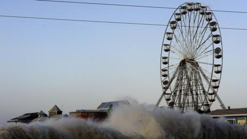 Angry seas, with high waves and much spray, pound Blackpool Central Pier during a previous storm.