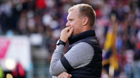 Liam Manning watching on from the touchline during a game this season