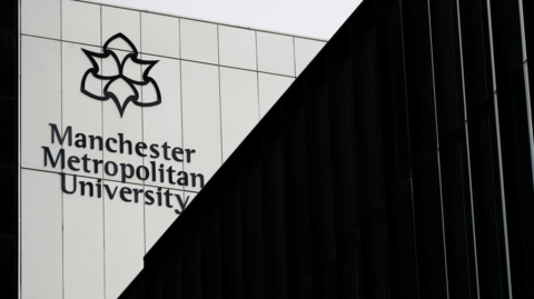 A general view of the Manchester Metropolitan University building, which is black and white.