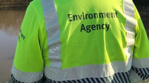 A hi-vis jacket with writing on from the rear.