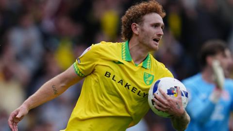 Josh Sargent holds a match ball after scoring for Norwich