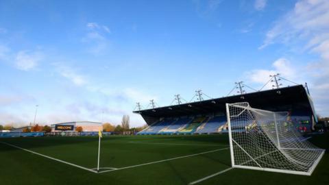 General view of the pitch, goal net and the stand at the Kassam Stadium in Oxford on a sunny autumn day. 