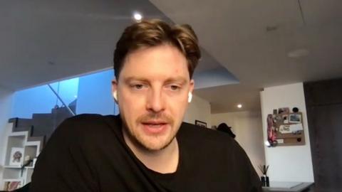 Dr Alex George, who has short hair and is wearing a black T-shirt, wants improved waiting times ADHD assessments