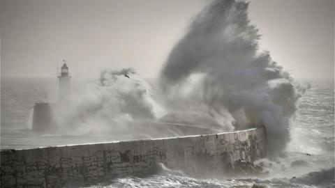Large waves crashing over the harbour wall at Newhaven, East Sussex